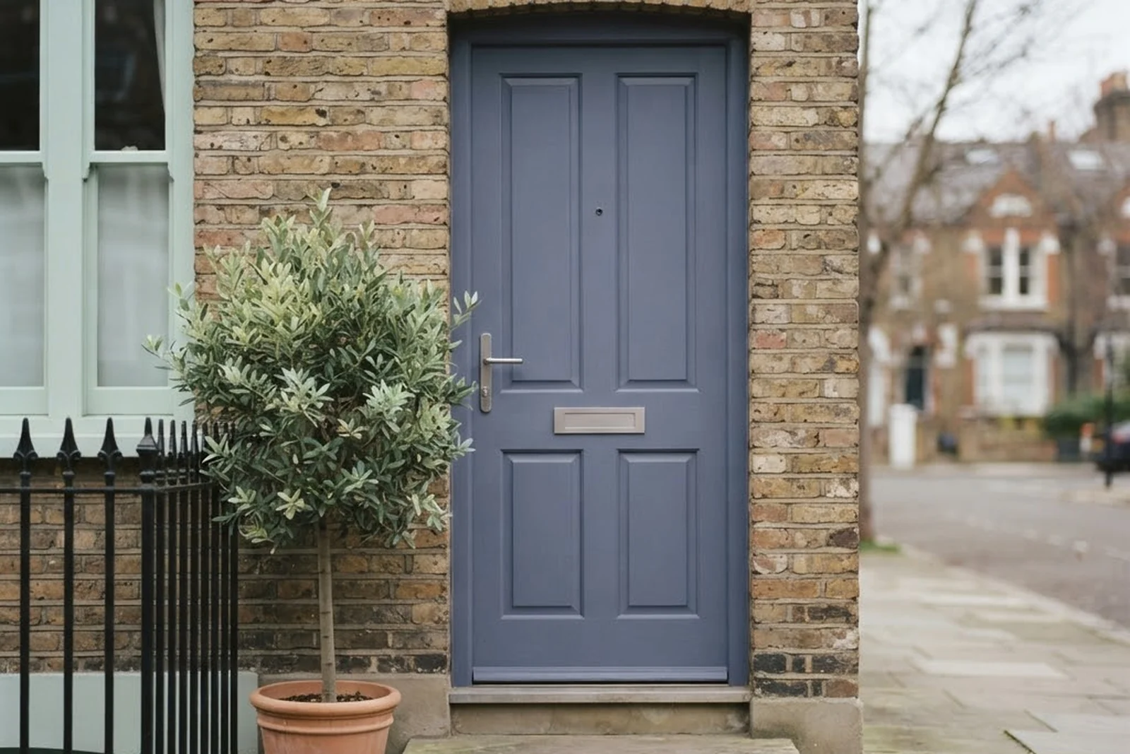 The painted front door of a city home